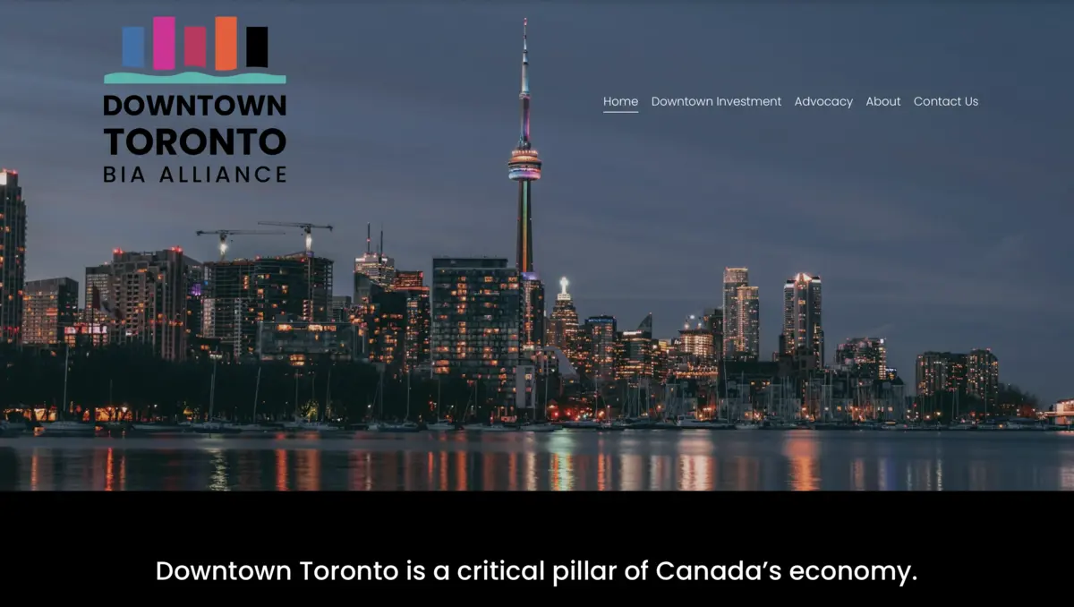 Logo for Downtown Toronto BIA Alliance over a night view of the Toronto skyline and CN Tower.