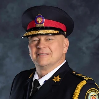 Portrait of a Toronto Police officer in full dress uniform and cap.